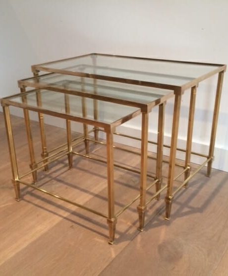 A brass and glass trio nesting table likely by Jansen