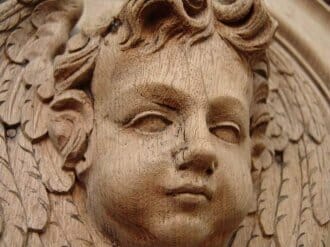 Bleached oak hand carved wooden angel in oak panel