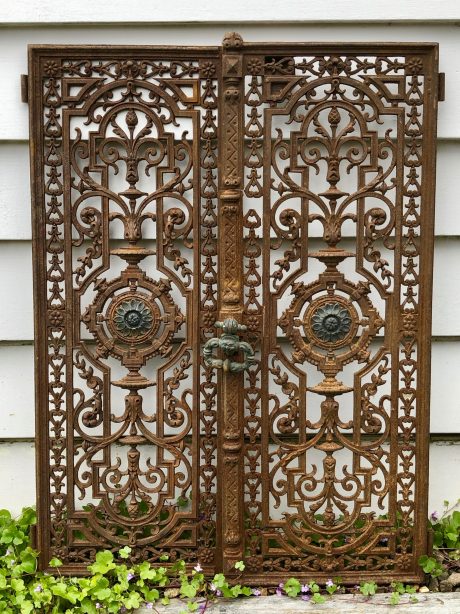 A pair of antique cast iron shutters (likely French or Italian)