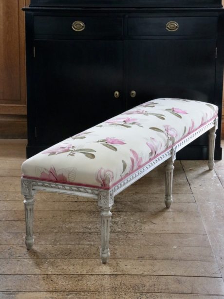 A painted Louis XVI style upholstered bench