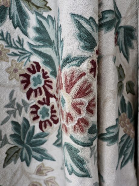 A crewel work wall hanging or bed covering