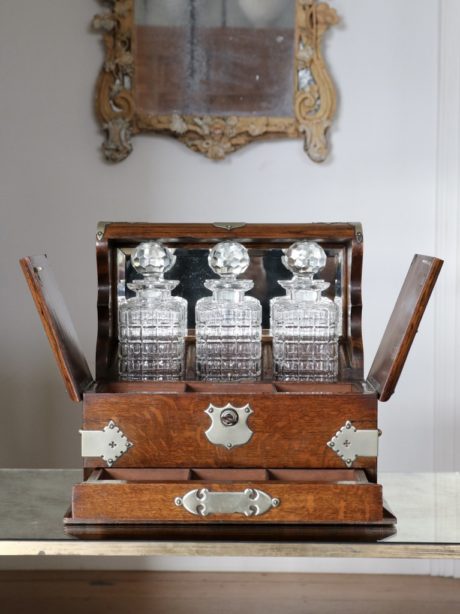 Antique English oak cased three decanter tantalus